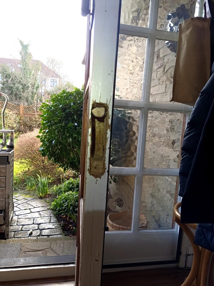 A mortice hole gouged out of a French door